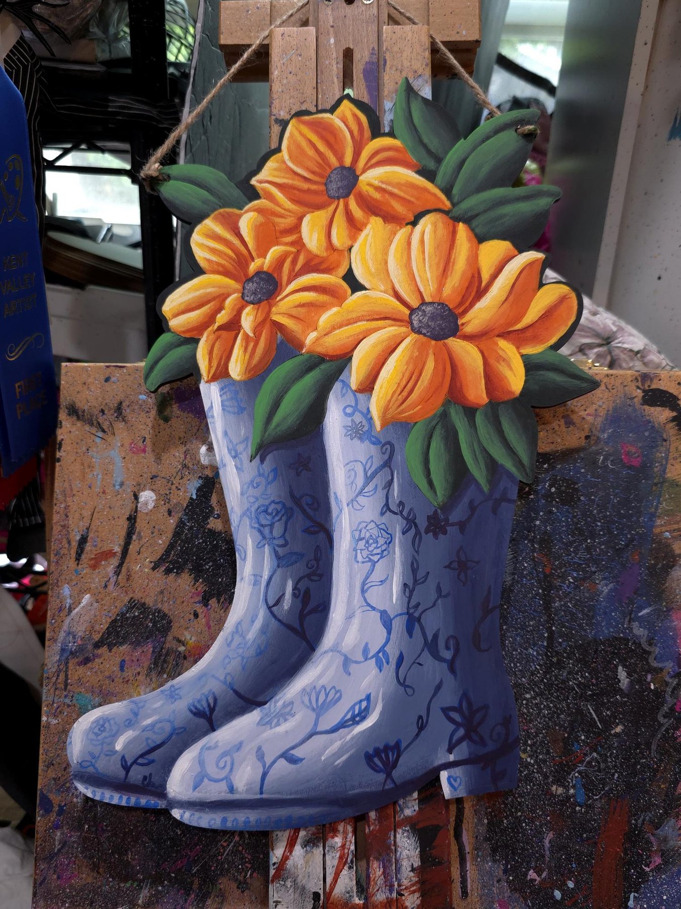 Porcelain Boots original with blue patterned boots holding orange flowers