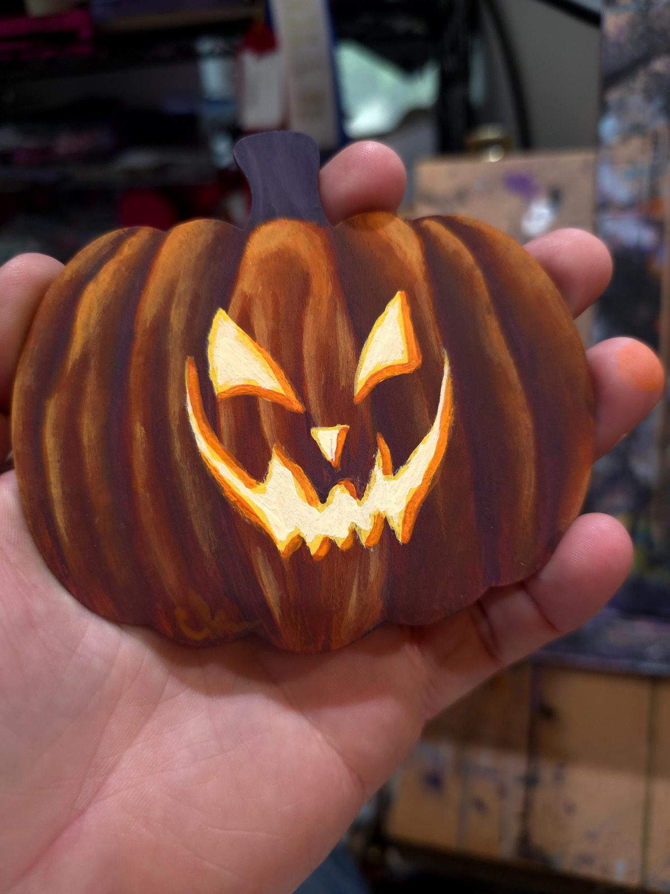 Small carved pumpkin with glowing jack-o-lantern face