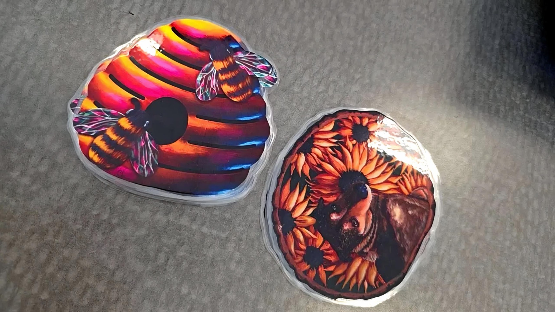Two round orange and red die-cut prints on a tabletop